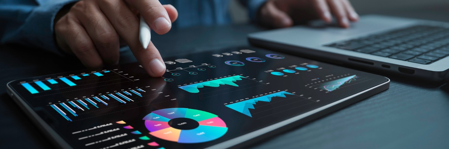 Banker using digital tools (tablet & PC) for financial analysis and investment activities